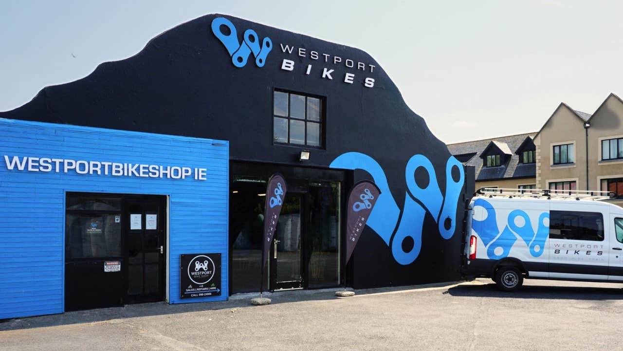The navy and blue exterior of a bike hire shop