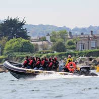 Goat Boat Tours view of a group speeding along the coast