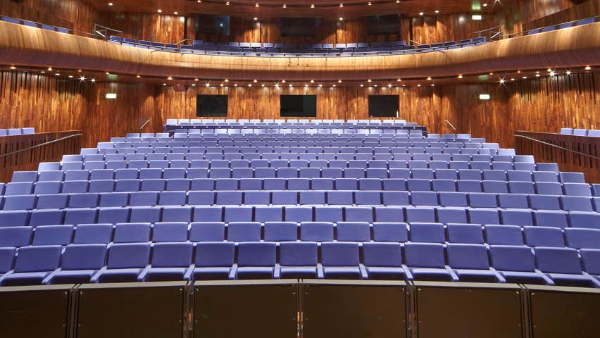 A view from a stage onto an empty seating area surrounded by a balcony