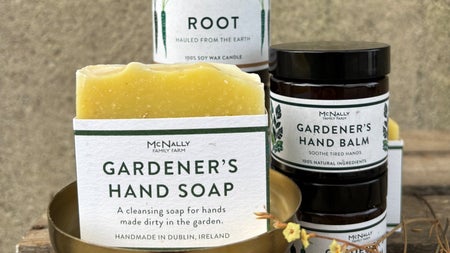 Yellow bar of McNallys soap and jars of cosmetics