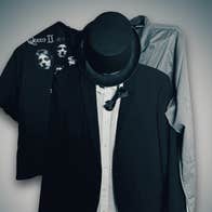 3 hangers on a wall with items of clothing on.