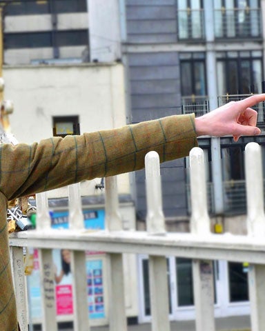 One of the guides called Garvan talking to a lady on the tour standing on the Halpenny Bridge and pointing down the river