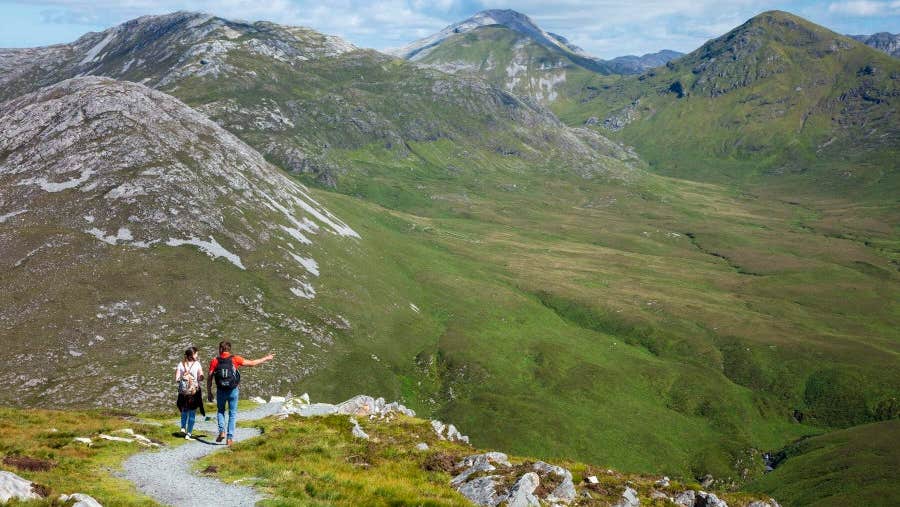 Couple walking with mountains facing them