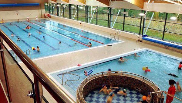 A swimming pool with a kiddies learner pool and jacuzzi also in the frame