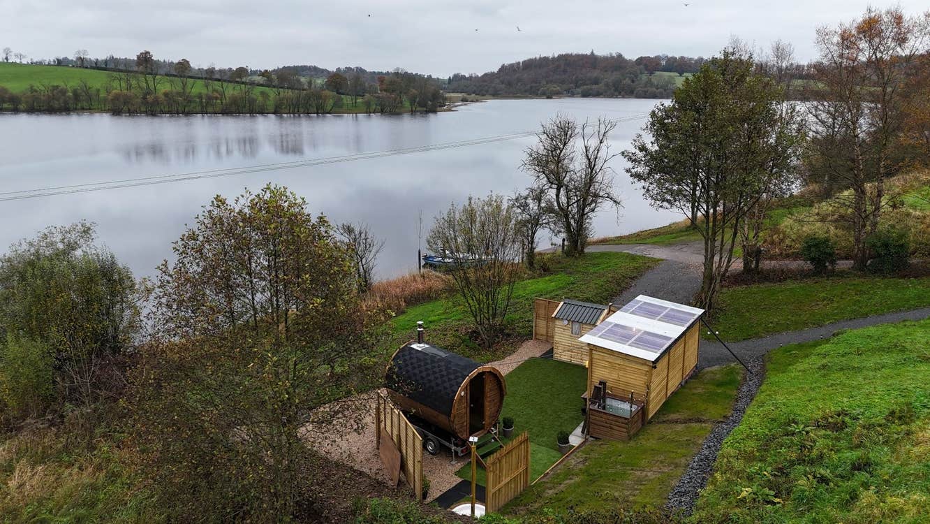 Wooden huts in a country setting overlooking a lake