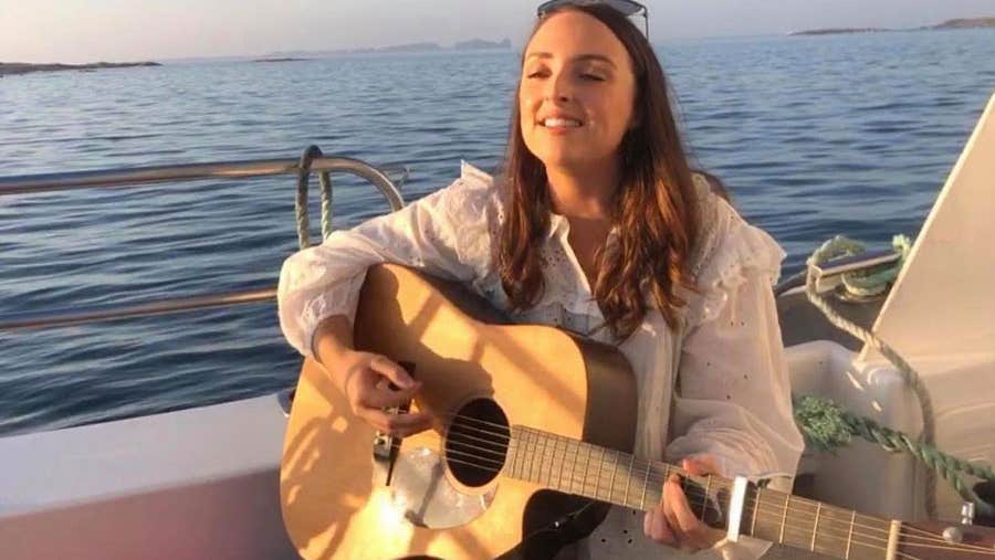 Guitarist performing on a sunset boat trip with Donegal Music Trails