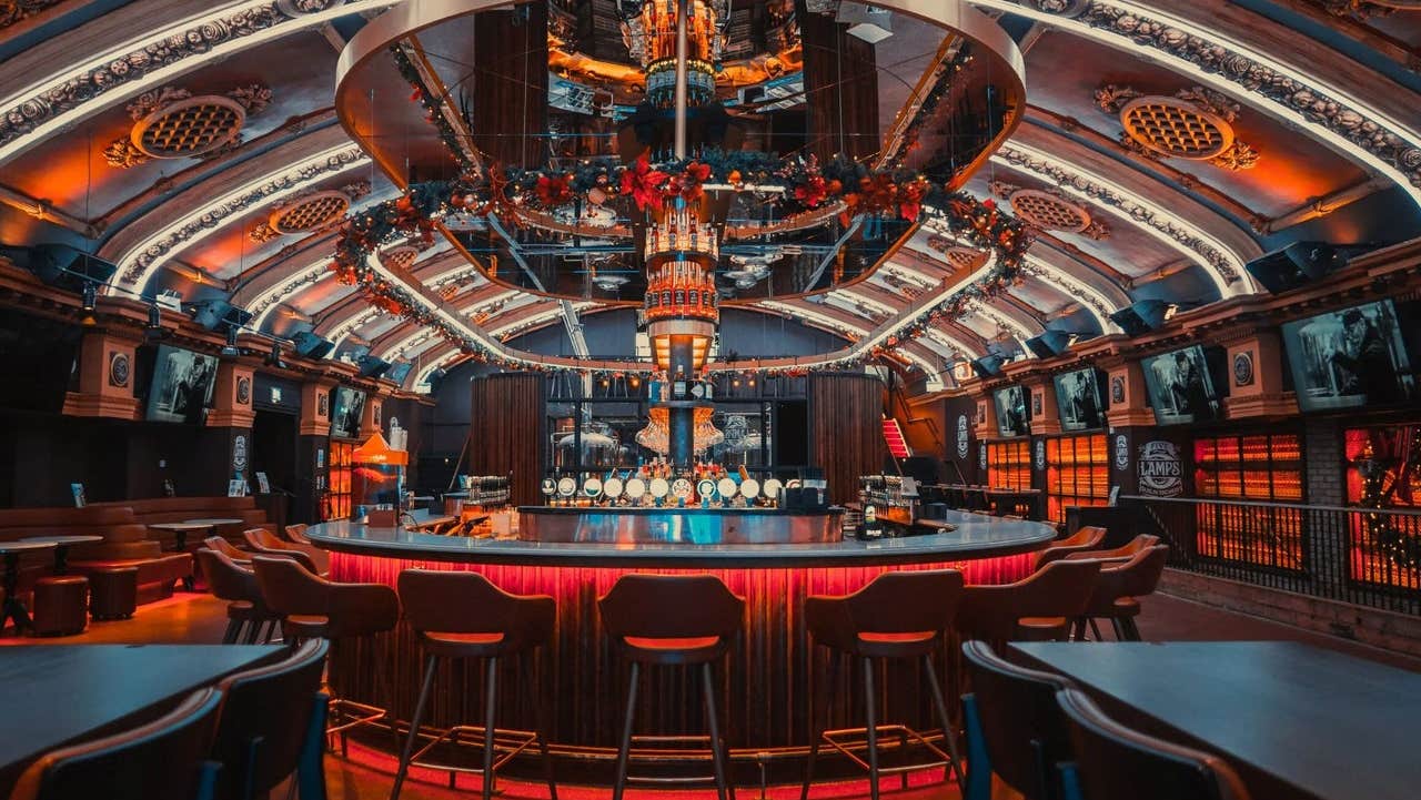 An illuminated circular bar featuring vaulted ceilings with architectural details