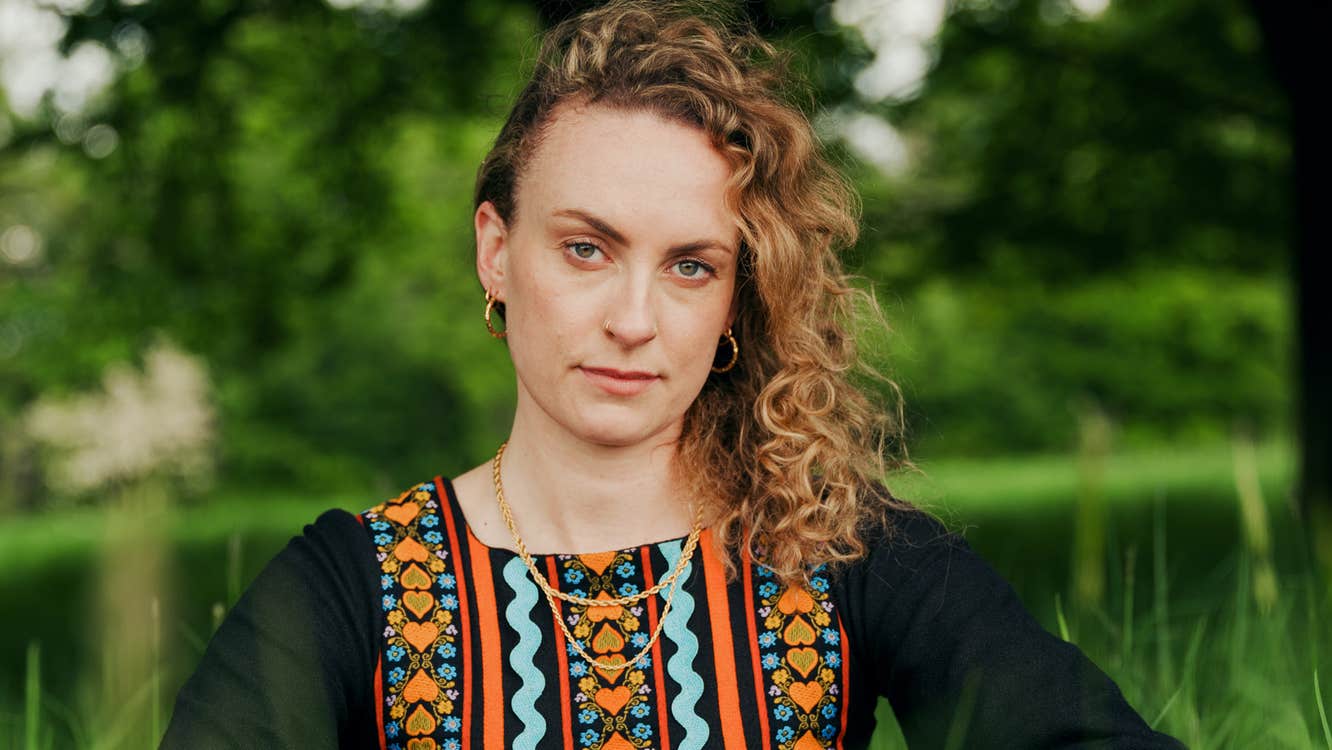 A woman outdoors in tall, green grass