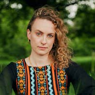 A woman outdoors in tall, green grass
