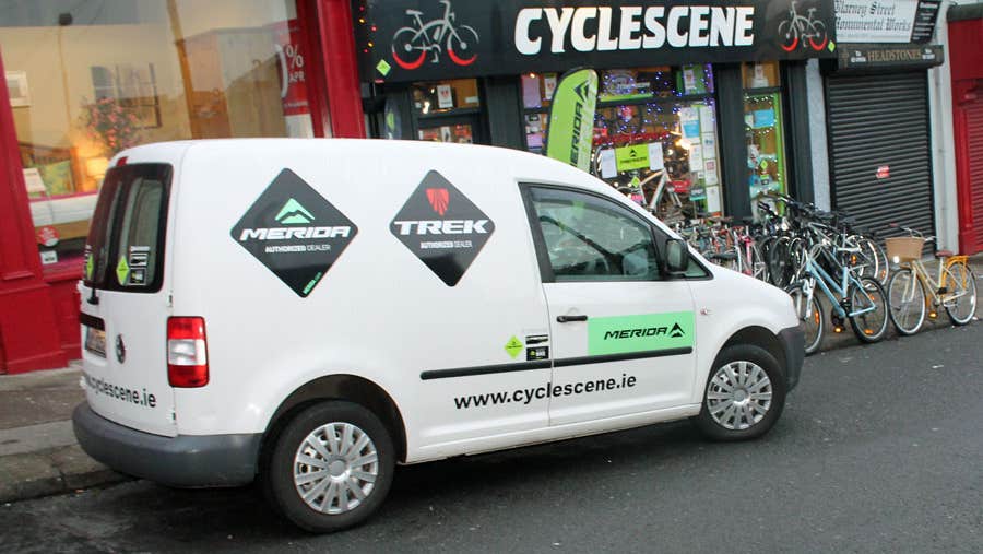 Cycle Scene shopfront with branded van and some bicycles outside