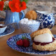 Freshly baked scones served with cream jam and tea in The Ballymaloe Shop and Café