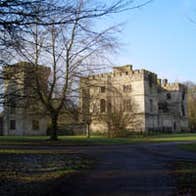 Trees in front of a large house in a park in Donadea Forest Park, County Kildare.