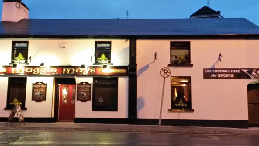 The exterior of Maggie Mays Restaurant in Loughrea on a darkening evening with the exterior lighting on
