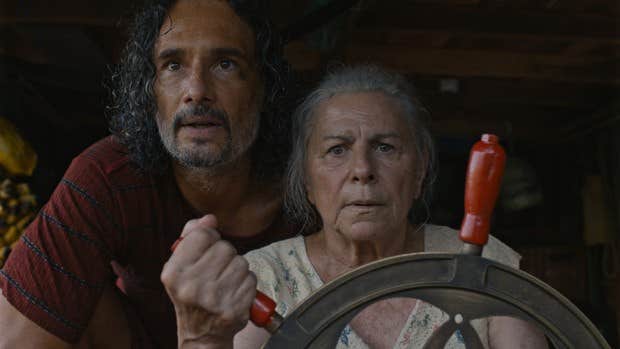 A worried looking older man and woman looking ahead.