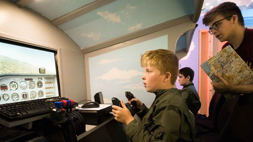 A boy taking a simulated flying lesson in the Shannon Aviation Museum
