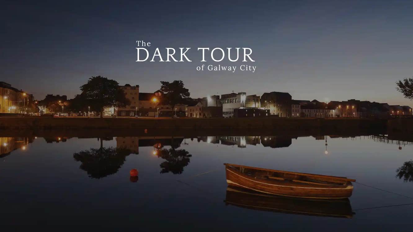 View across water at dusk with city in the distance