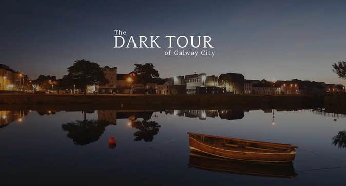 View across water at dusk with city in the distance