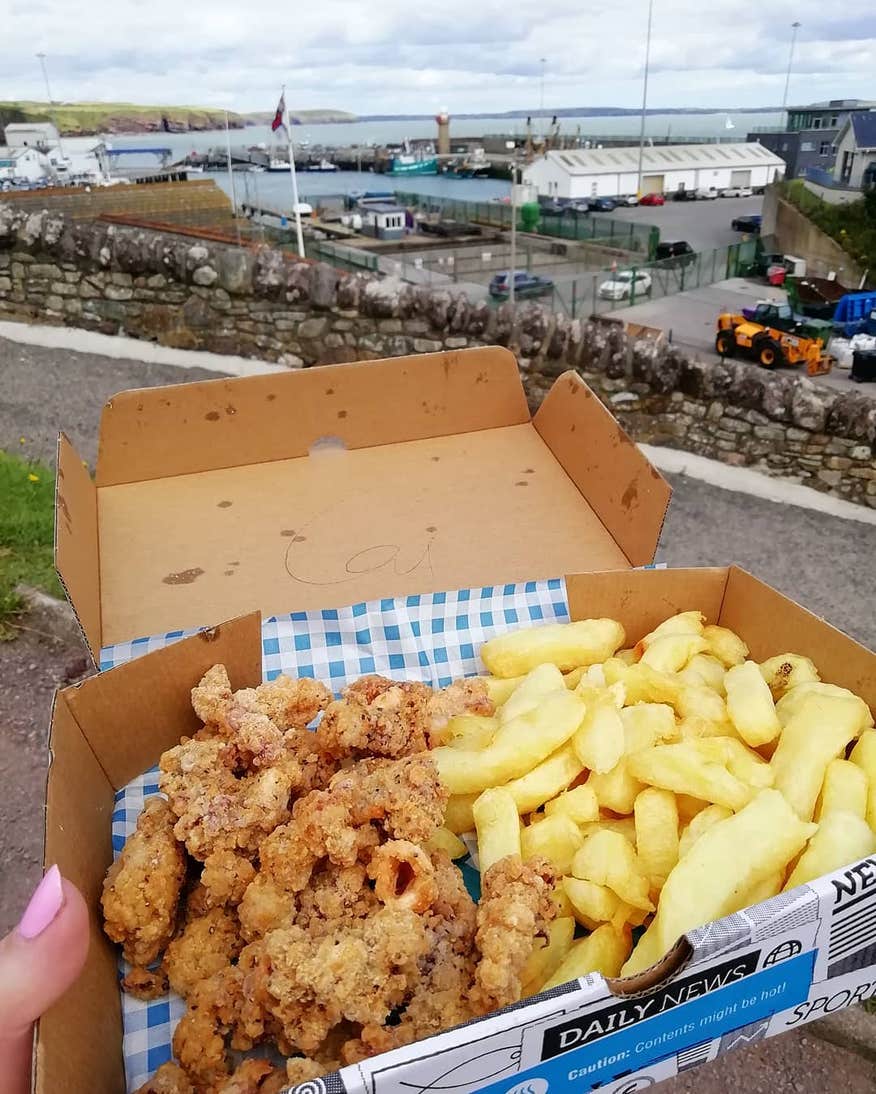 A container of fried fish and chips