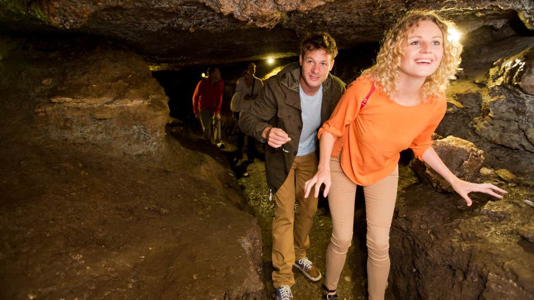 Two people exploring Mitchelstown Cave, Tipperary