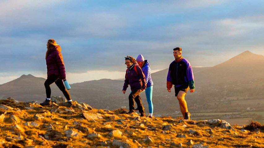 Four people hiking in Wicklow mountains on a Hilltop Treks tour