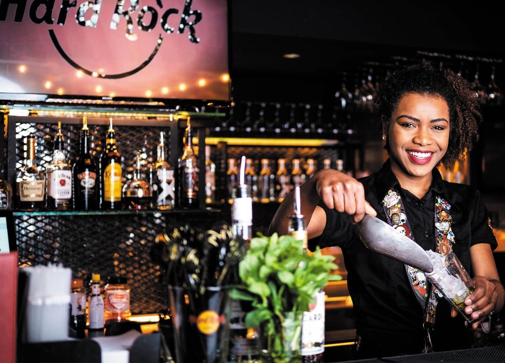 Bar person preparing a cocktail