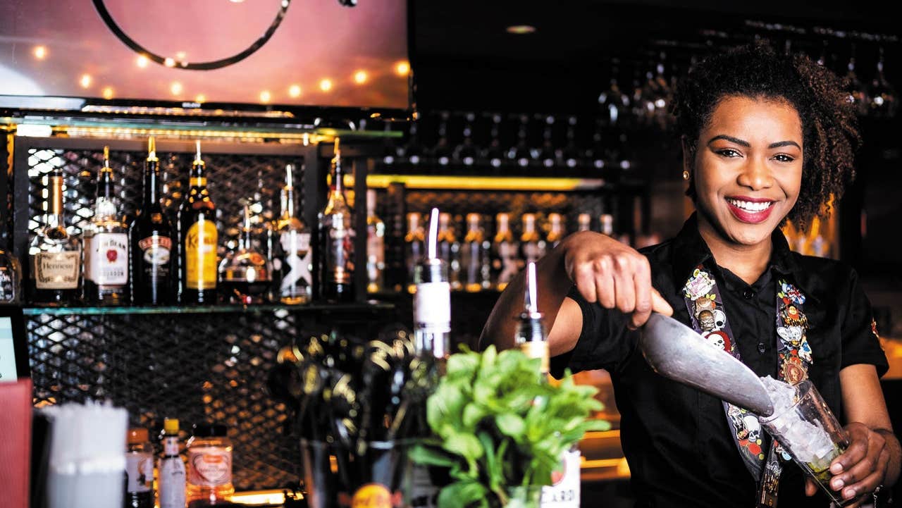 Bar person preparing a cocktail