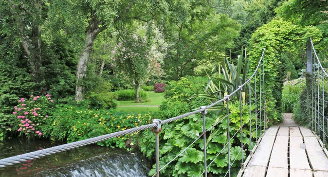 Mount Usher Gardens views of the footbridge, waterfall, flowers and mature trees
