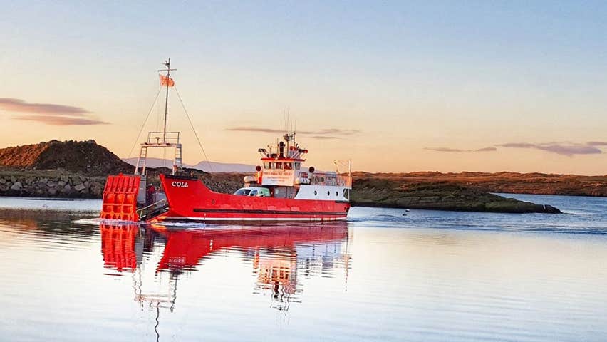 The Arranmore Car Ferry on its way to Arranmore Island with some hills in the background