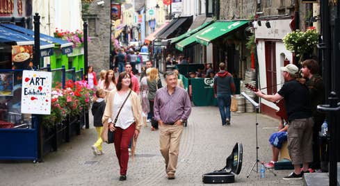 Couple walking down lively streets in Kilkenny City 