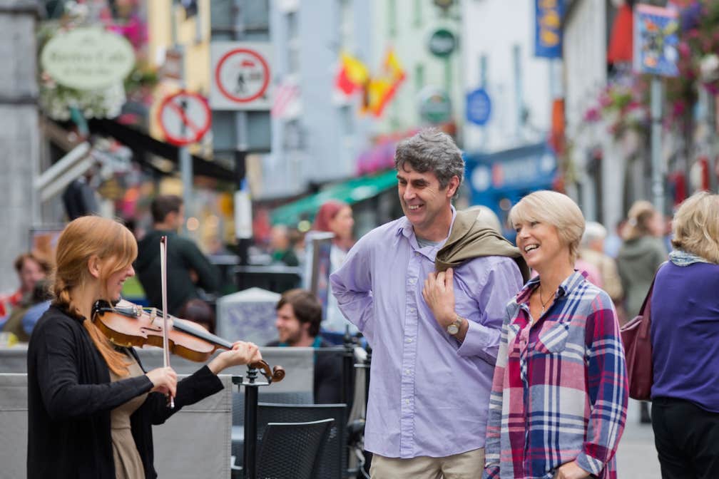 Musician busking on Galway City centre street, County Galway