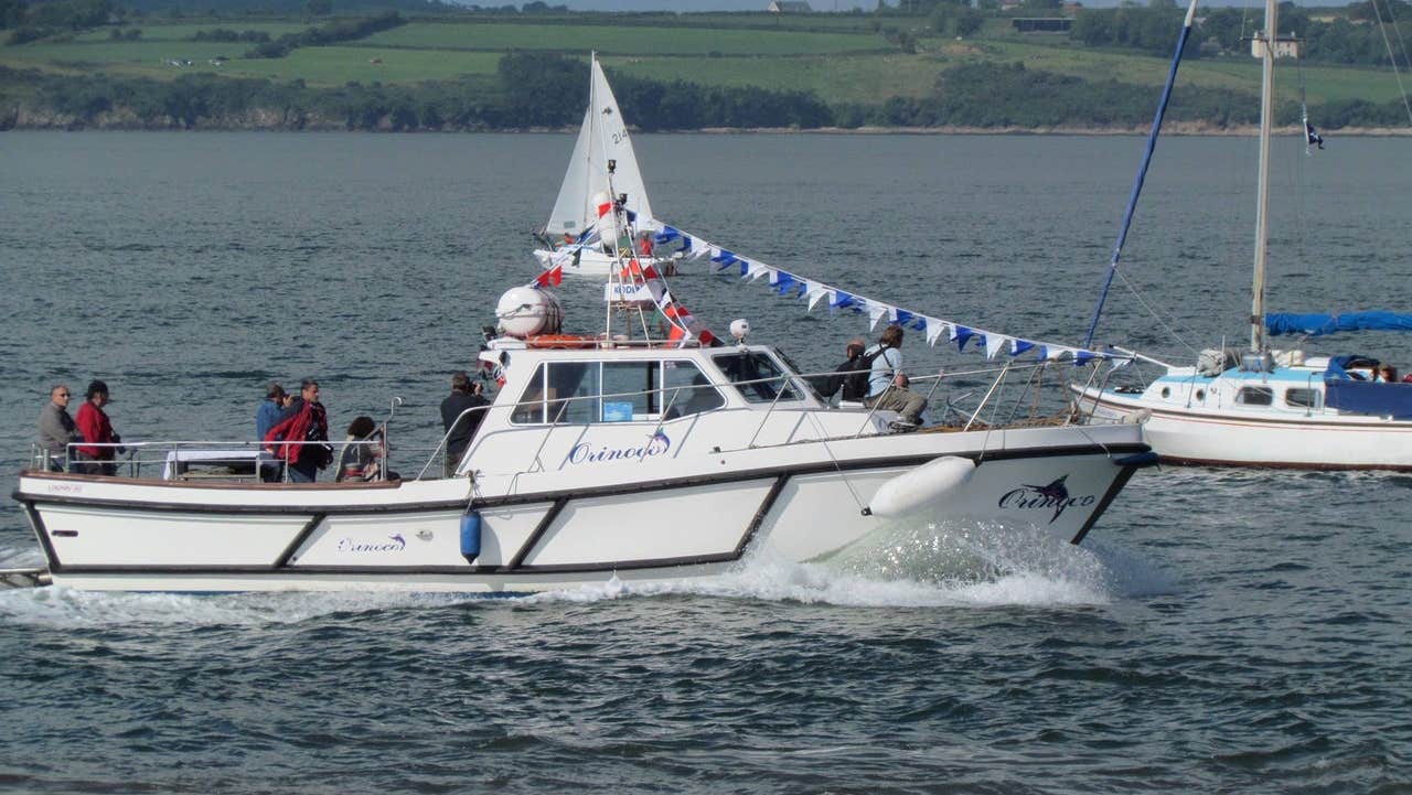 A boat at sea with some passengers onboard