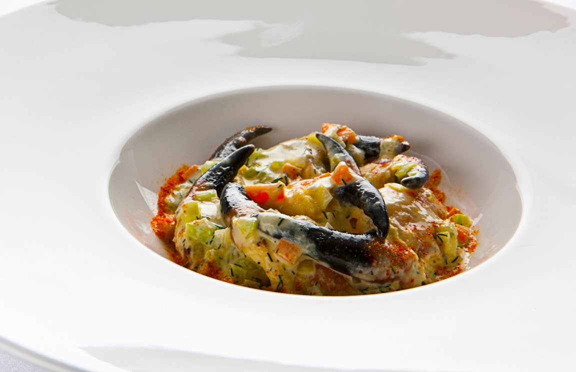 A dish of crabs claws served in a white plate