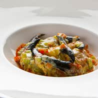 A dish of crabs claws served in a white plate