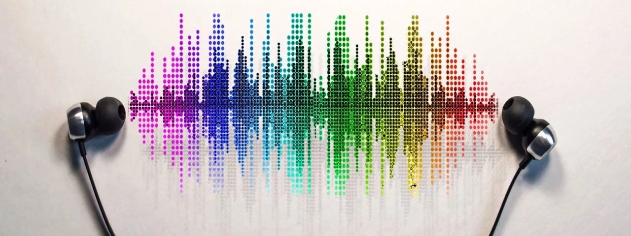 A pair of earbuds with wires are laid on white surface with multicoloured music waves between them.