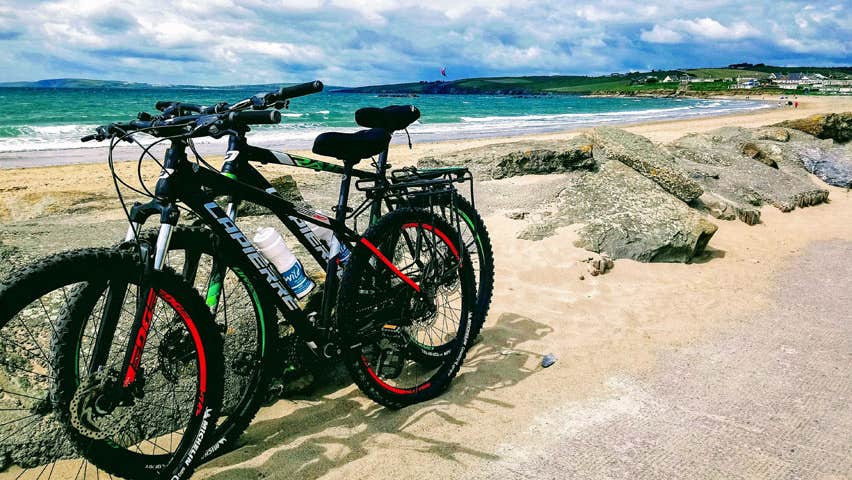 Two bikes parked up with Garrettstown Beach and the sea in the background
