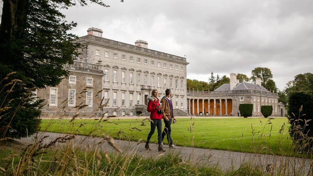 Two people walking on the grounds of Castletown House
