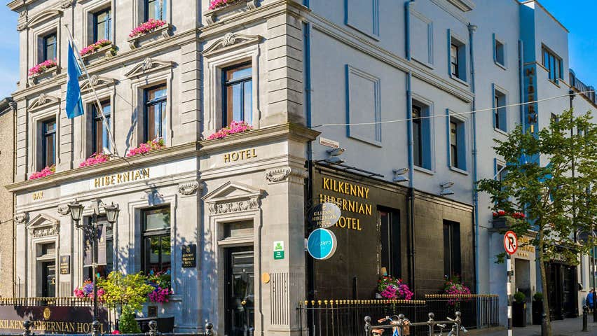A view of the external of the Kilkenny Hibernian Hotel in Kilkenny City with a blue sky in the background