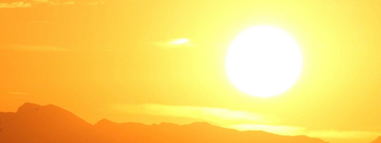 An image depicting a sun low in the sky at evening