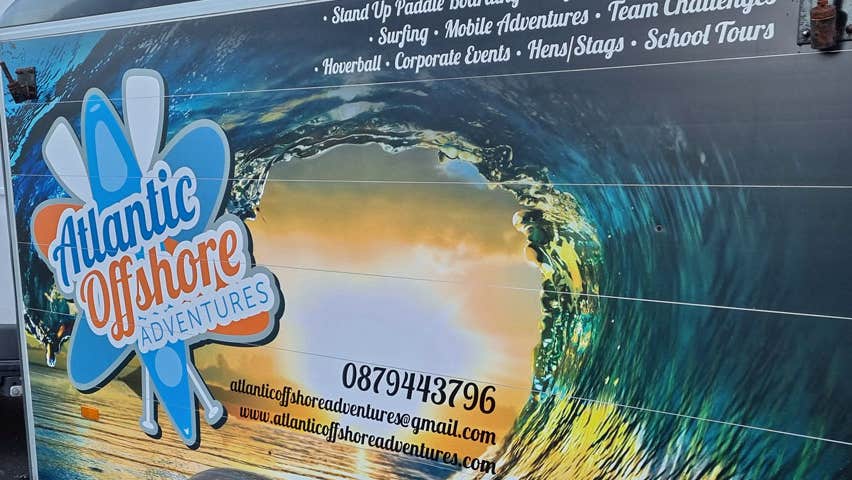 Trailer attached to a van showing logo and contact number for Atlantic Offshore Adventures