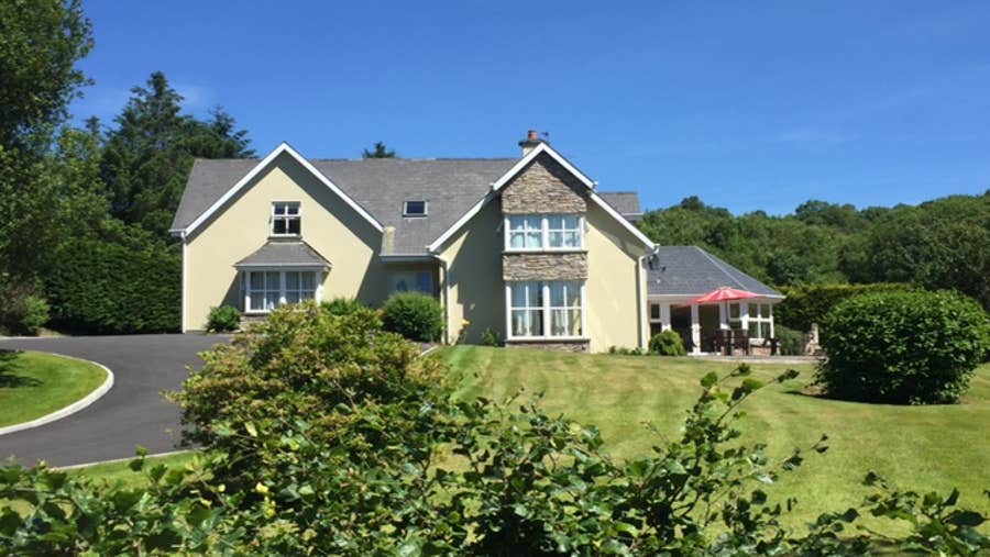 Front of yellow house with garden
