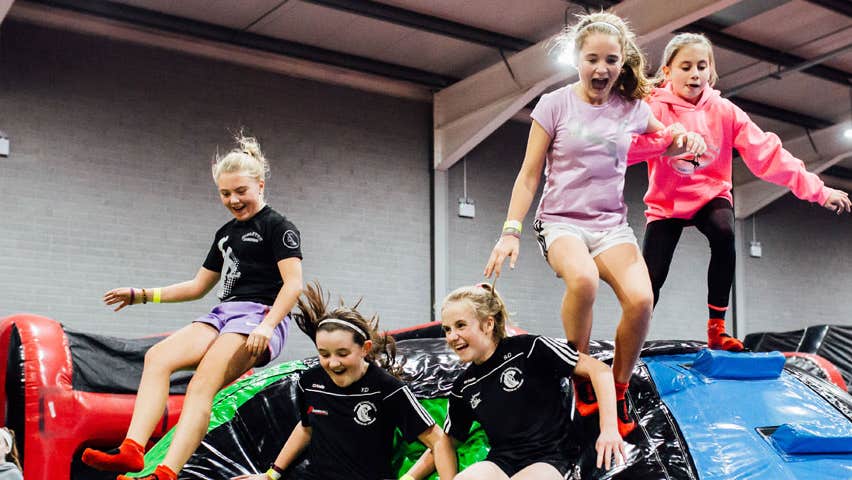 A group of children enjoying the Inflata drop slides