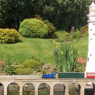 Miniature train going over a miniature railway viaduct at West Cork Model Railway Villiage