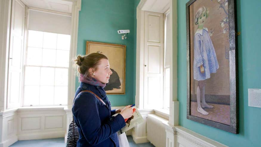 Woman admiring a painting of a young girl at The Hunt Museum in Limerick