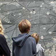 Tour guide showing her group the Grace Weir Viking Wall