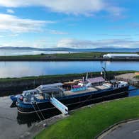 Escape boat moored at the dock with views across the surrounding harbour