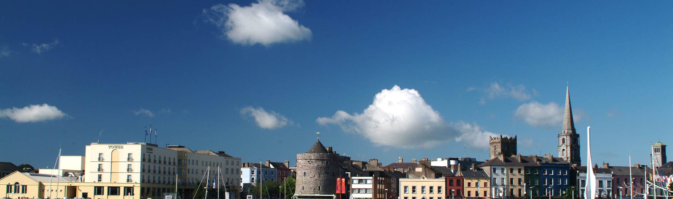 View Of Waterford Quay in Waterford City on a sunny day with buildings in the background.