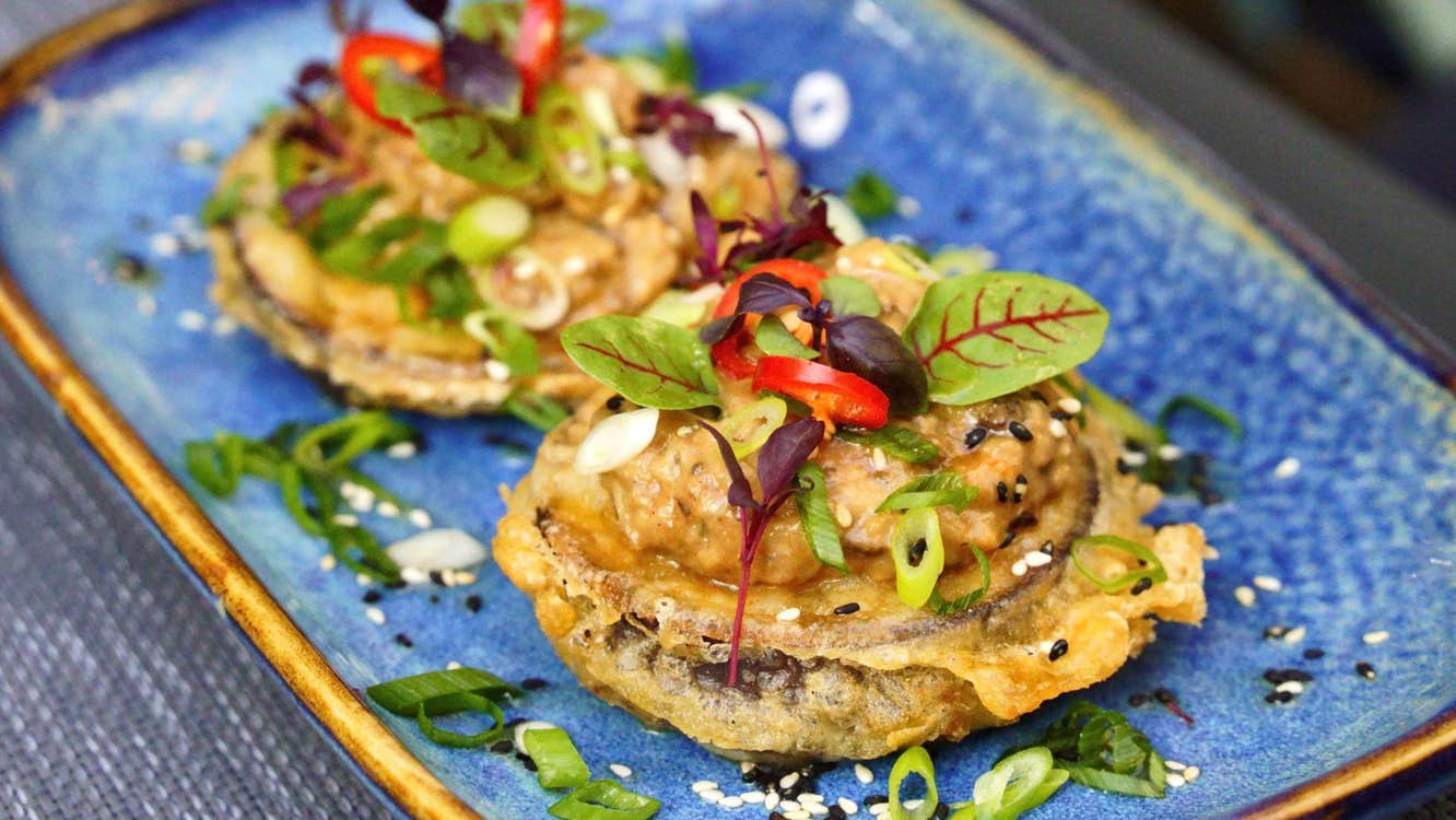 A ceramic dish with two small circular morsels