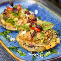 A ceramic dish with two small circular morsels