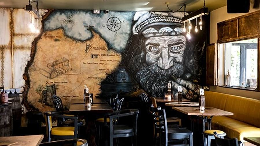 A wall decorated with a mural in Smuggler's Rest