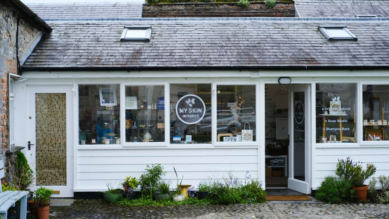 A white shed like structure converted into a retail and workshop space